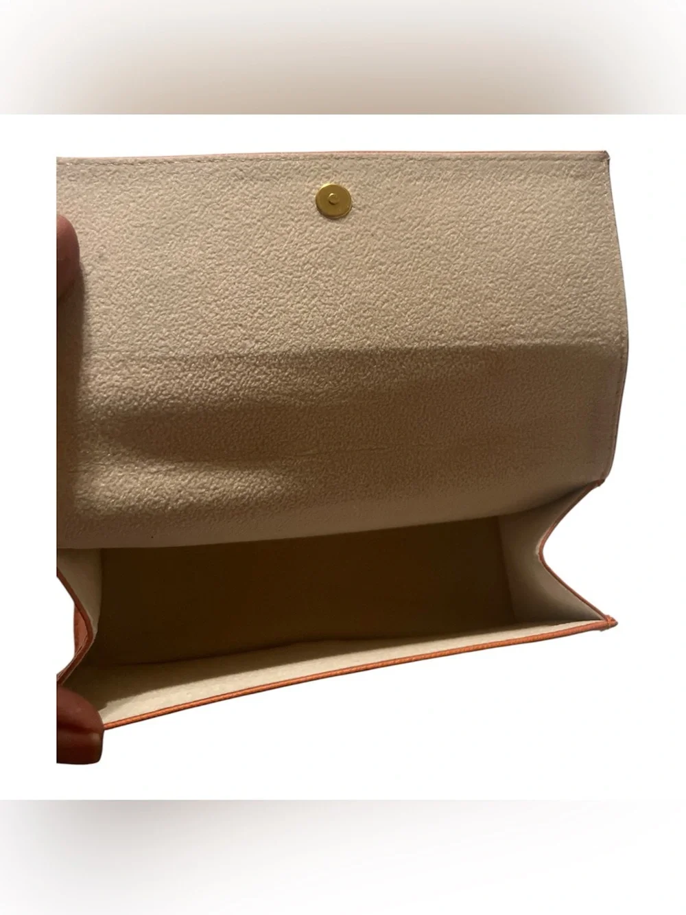 Tory Burch orange textured leather sunglasses case featuring a gold-tone logo